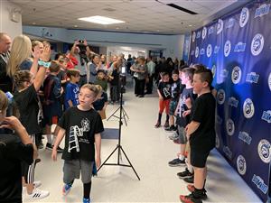 Patton used their new logos and colors to create excitement at an art show with a photo backdrop. 