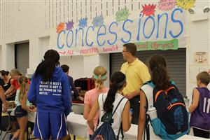 Director of Technology & Assessment, Chris Fahnoe, volunteers at the concession stand for the Brave Challenge Friday night. 